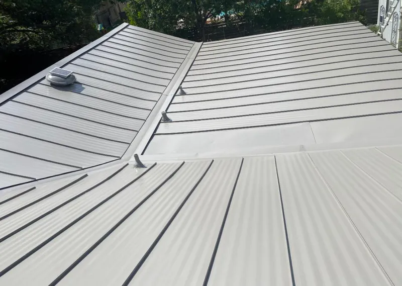 Solar attic fan installed on a metal roof for Roof Ventilation in Grants